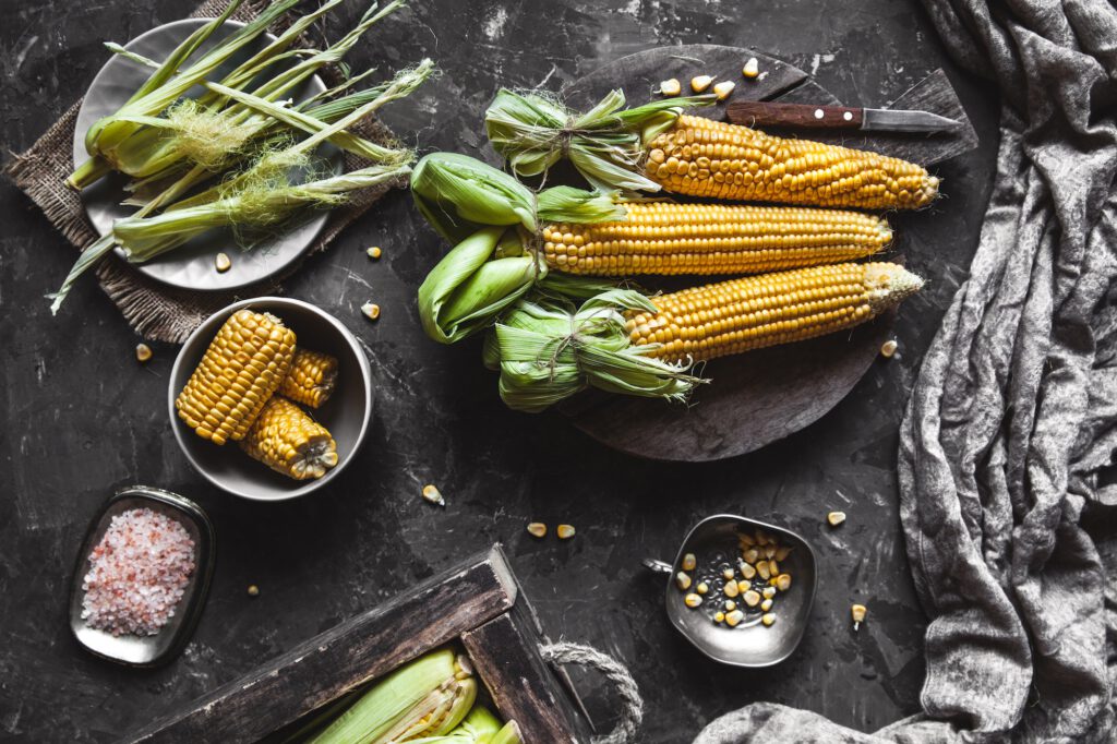 Grilled corn cobs with sauce, coriande. Mexican food. Top view. Copy space, healthy food, vegetables